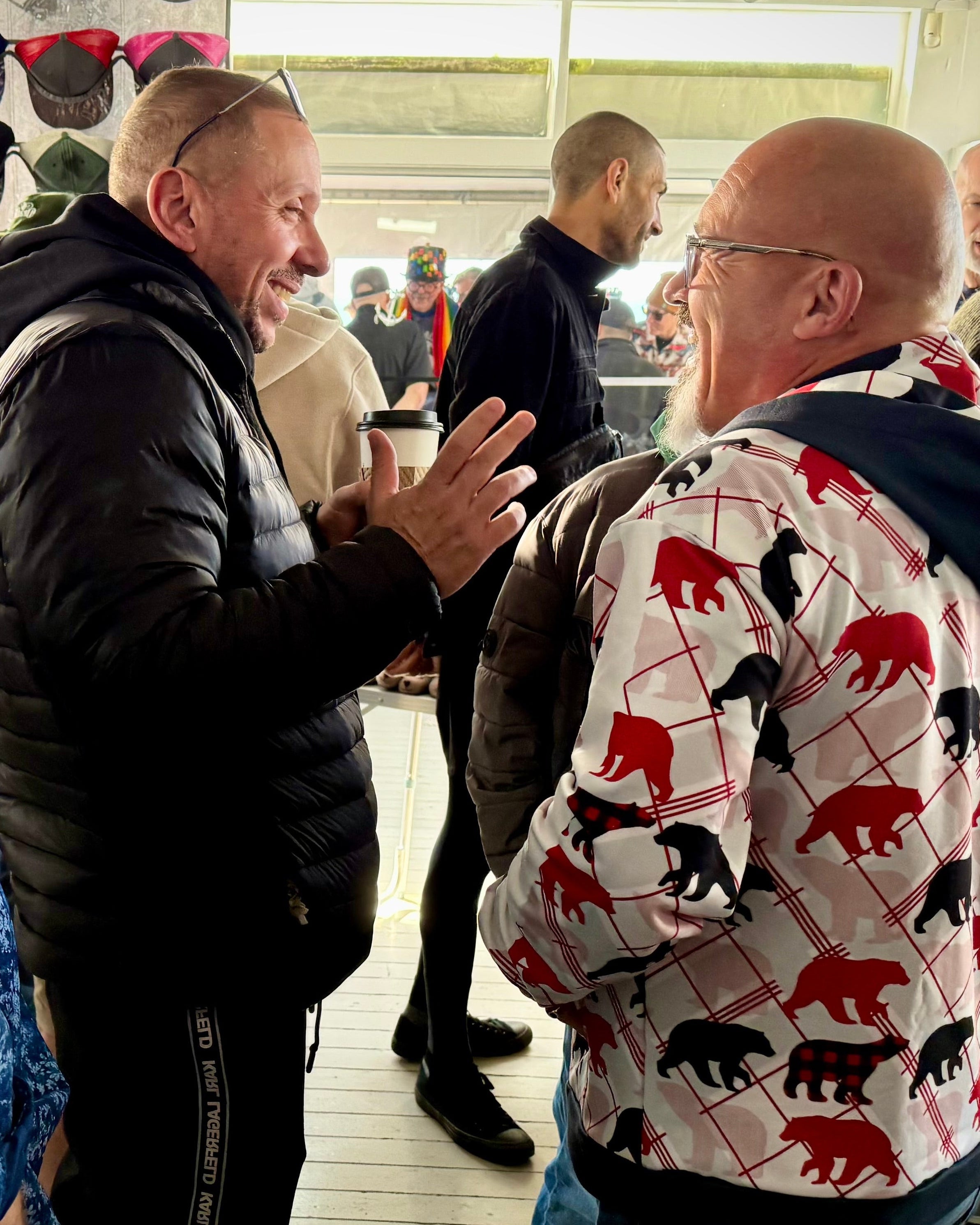Group of people interacting on a wooden deck with a building in the background