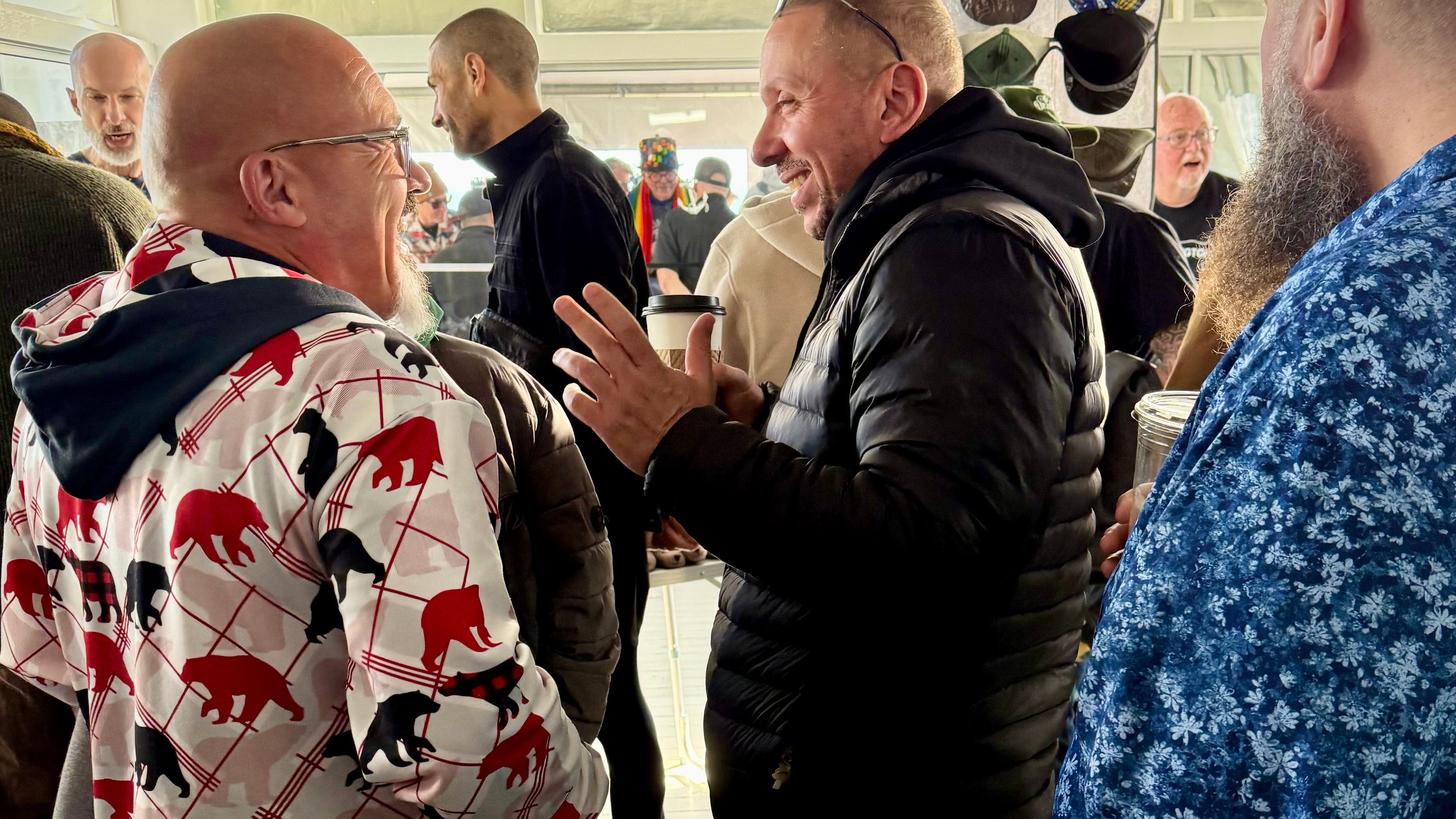 Group of people interacting on a wooden deck with a building in the background